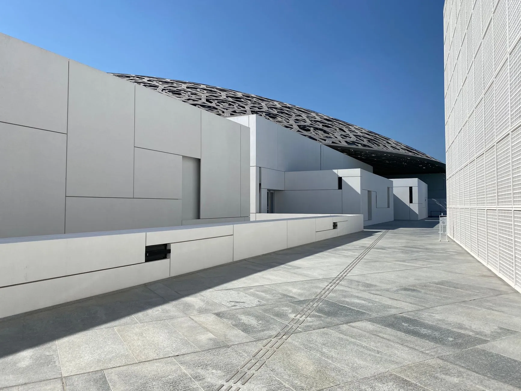 Louvre Abu Dhabi exterior with perforated dome creating rain of light