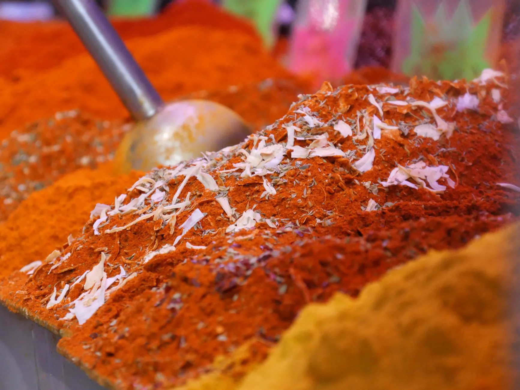 Colourful spice market stall with mounds of saffron and cardamom