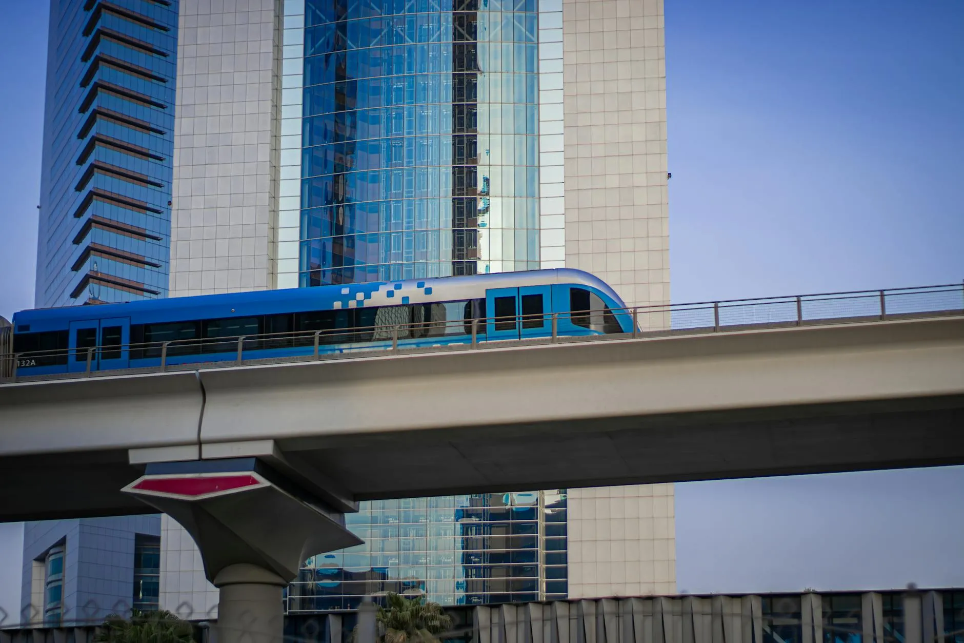 Dubai Metro train running along elevated track with skyscrapers