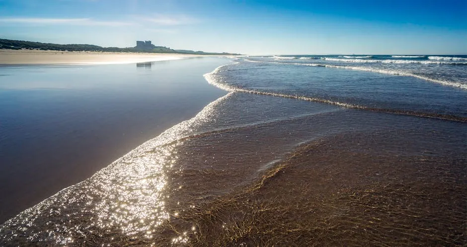 Bamburgh Castle towering above a vast sandy beach