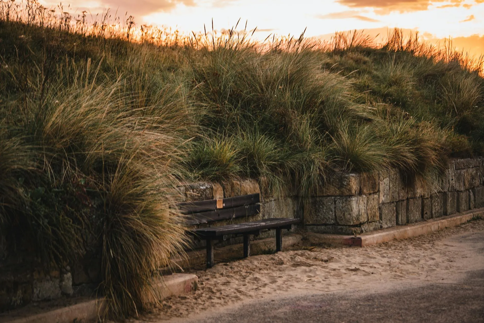 Golden sunset over rolling British countryside with stone walls