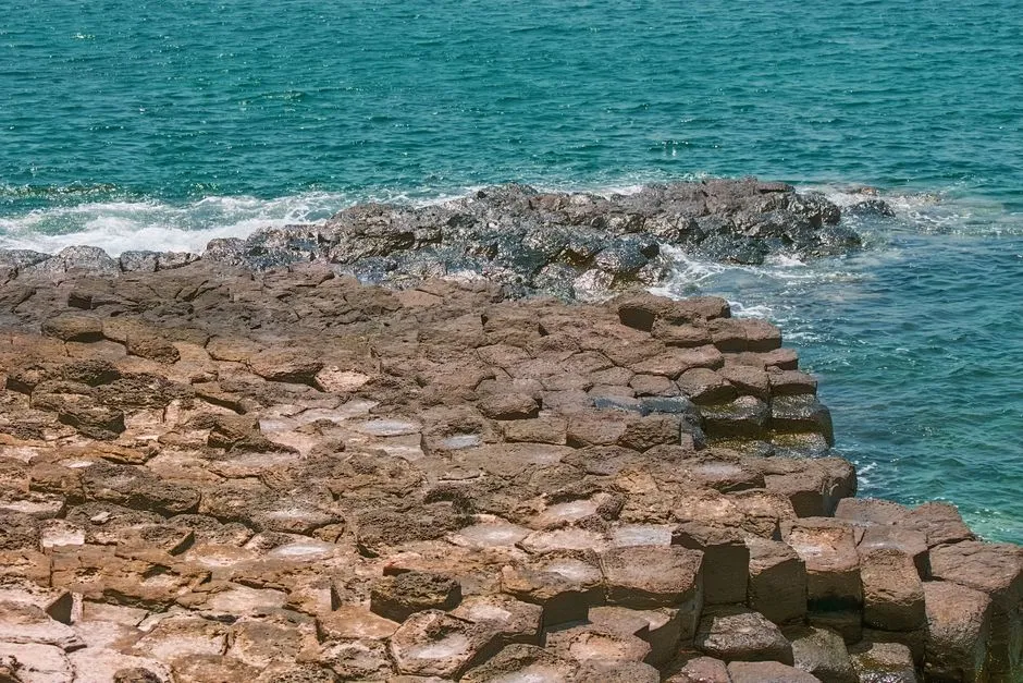 Hexagonal basalt columns of the Giant's Causeway stretching into the sea