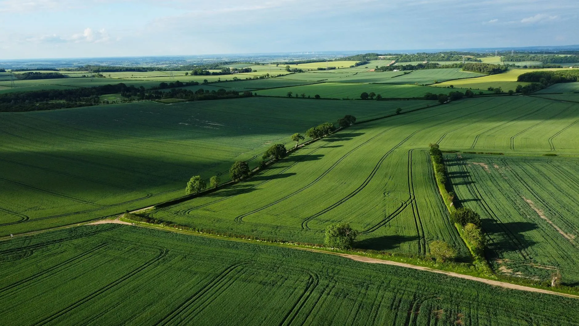 Aerial view across the diverse British landscape from green hills to rugged coastline