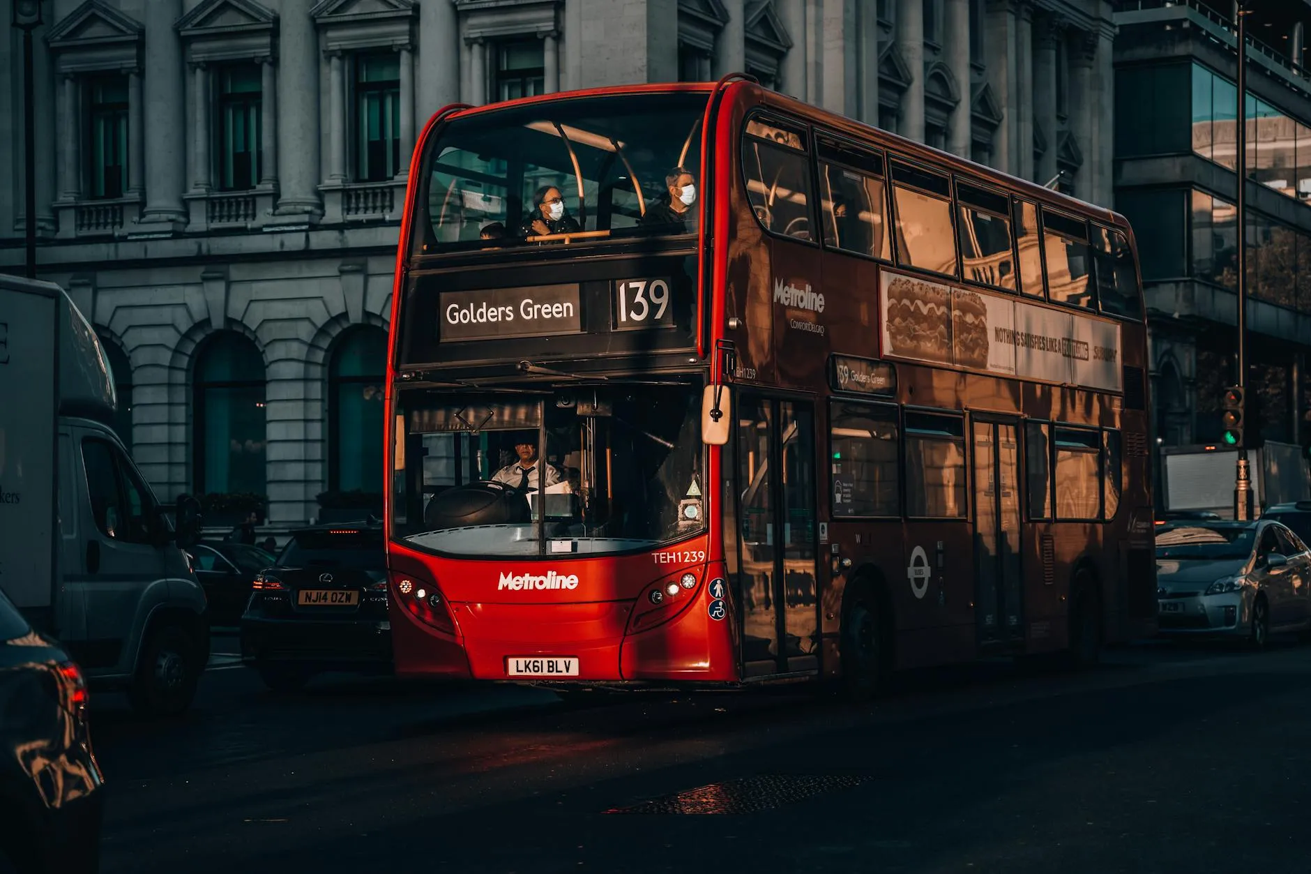 Red double-decker bus crossing Westminster Bridge with Big Ben