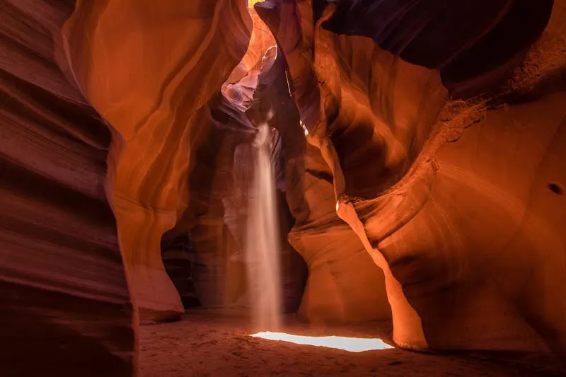 Light beam cutting through Antelope Canyon slot canyon walls