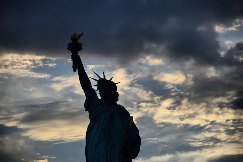 Manhattan skyline with Statue of Liberty at dusk