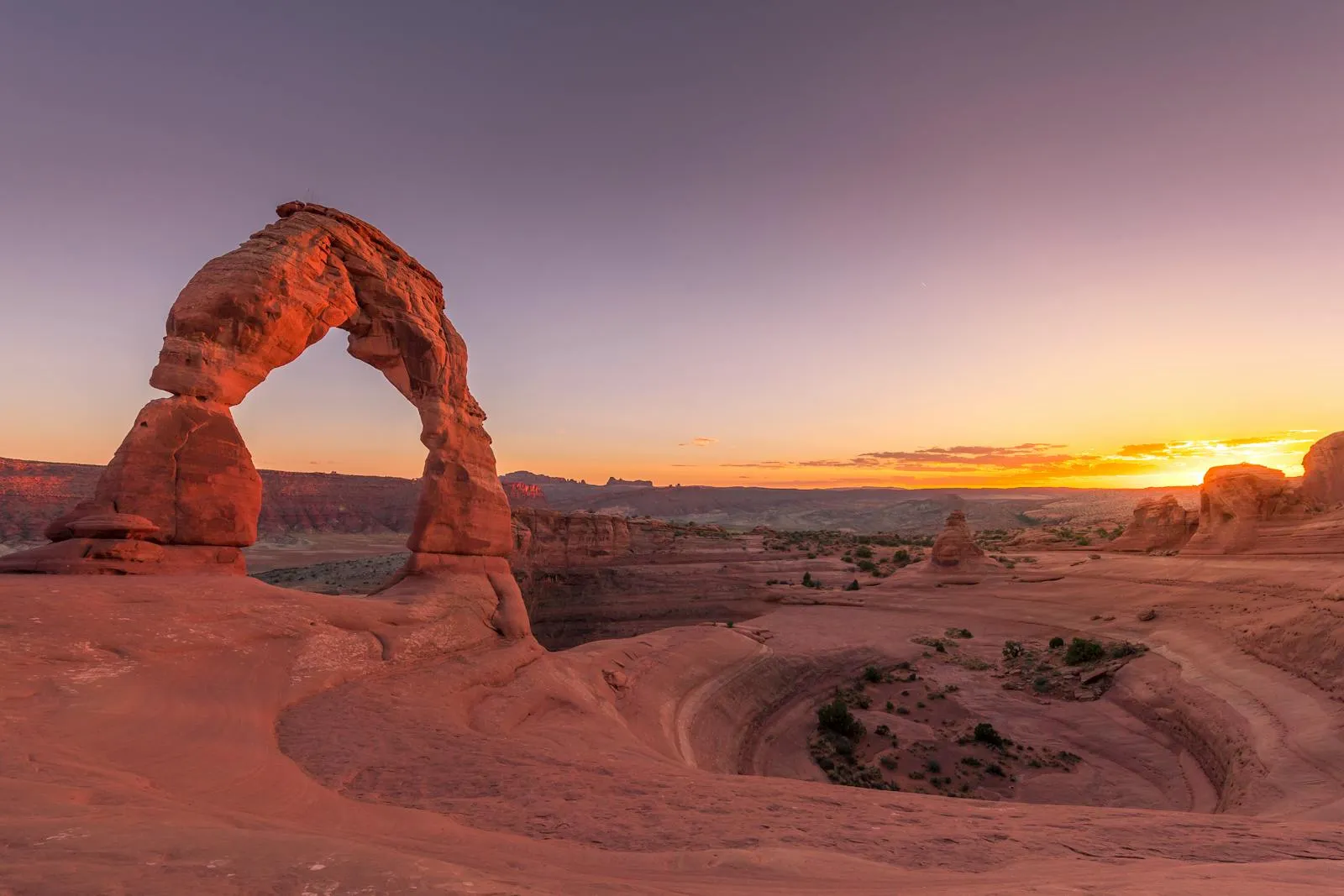 Delicate Arch in Arches National Park glowing at sunset