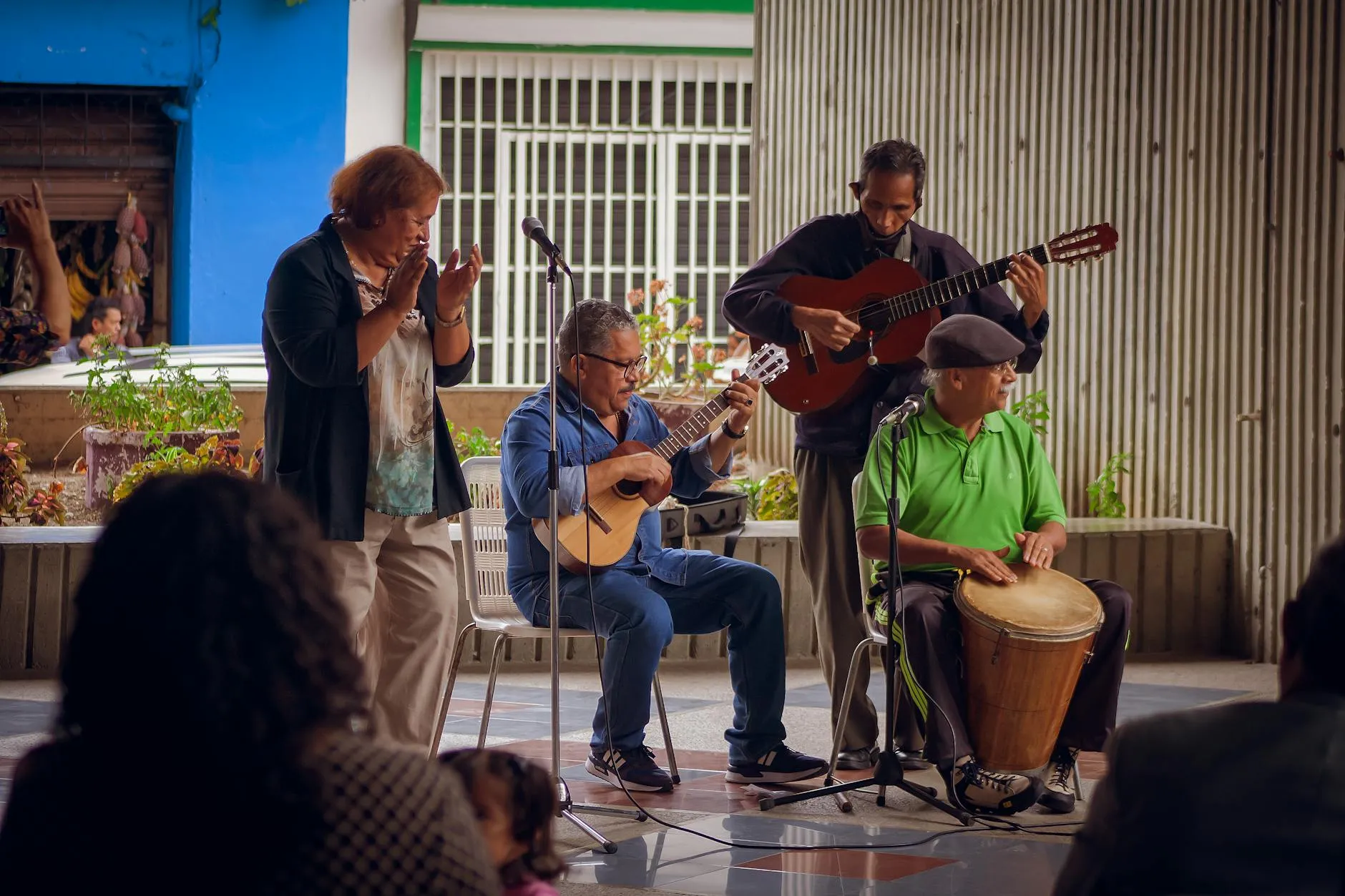 A diverse group of senior musicians performing outdoors in Venezuela, showcasing traditional musical talent.