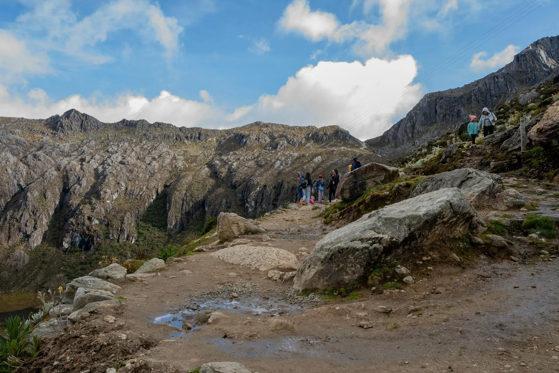 Explore the rugged beauty of Mérida's mountain range with hikers on a scenic trail.