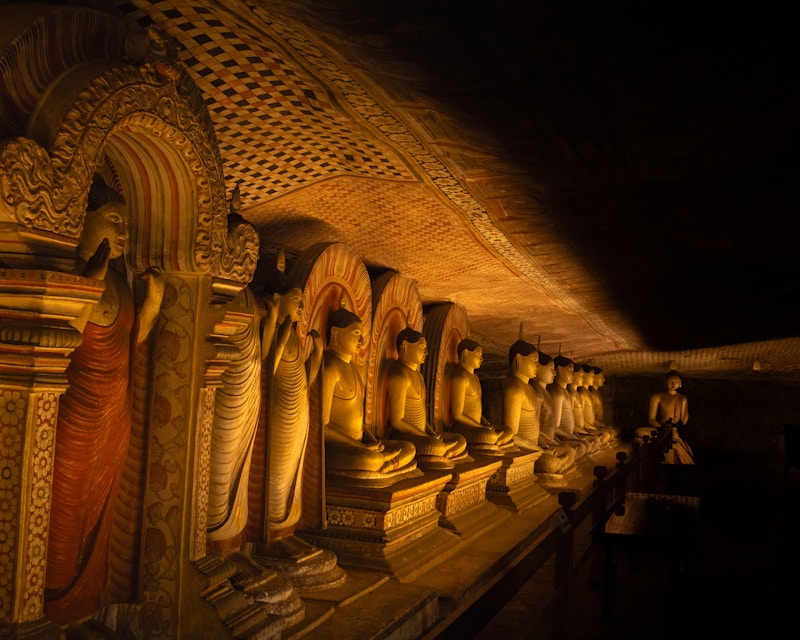 Row of golden Buddha statues in Dambulla cave temple